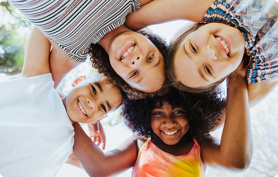 Smiling Group Of Children In A Circle Looking Down
