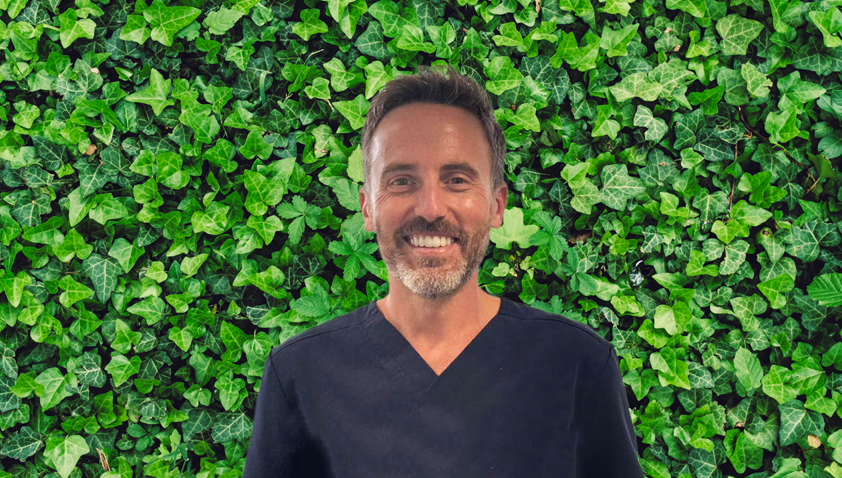 Dr Adam Joseph Rudmann In Front Of An Ivy Wall